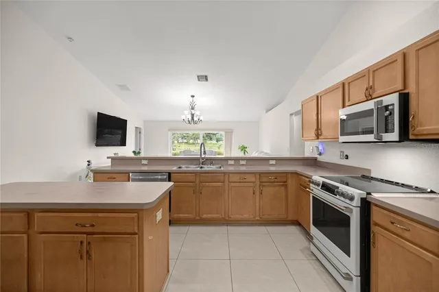 a kitchen with a sink stove and microwave