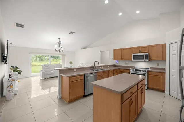 a kitchen with a stove top oven and sink