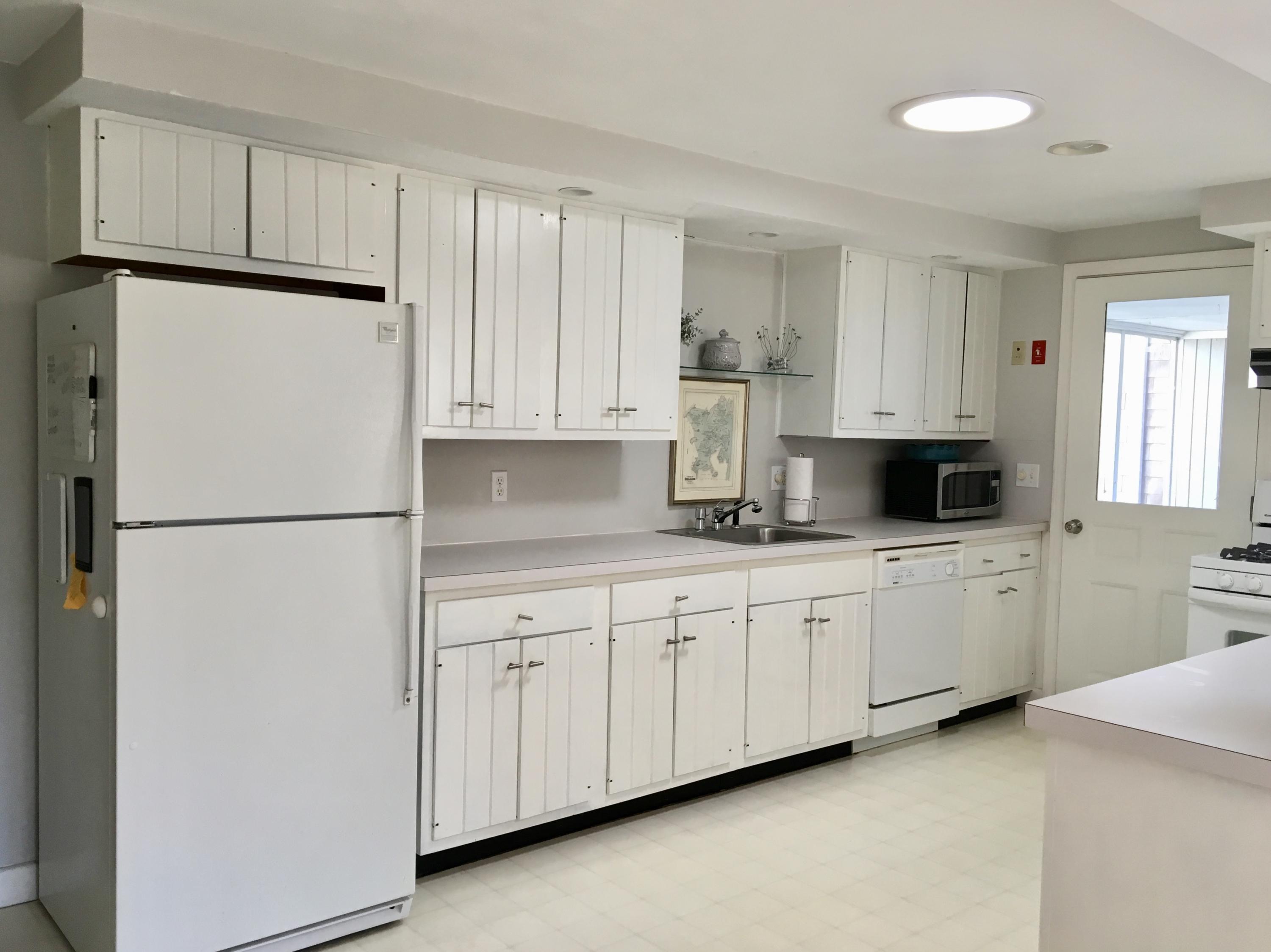 19 Seavers Road Orleans, MA 02653 - Photo 24 of 33 a kitchen with granite countertop white cabinets and refrigerator