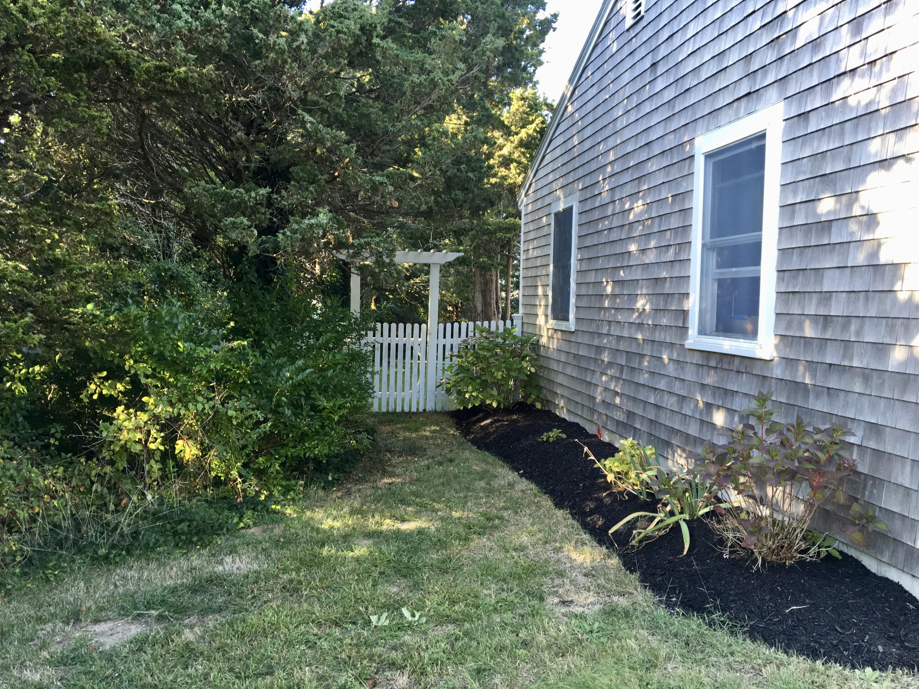 19 Seavers Road Orleans, MA 02653 - Photo 29 of 33 a view of a backyard with chair and a potted plant