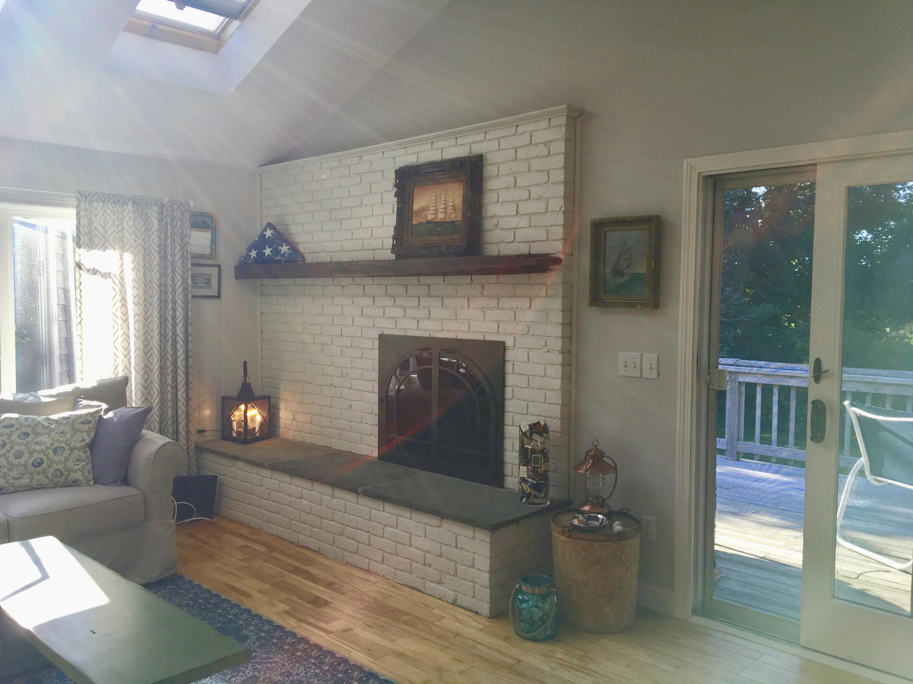 19 Seavers Road Orleans, MA 02653 - Photo 8 of 33 a living room with furniture and a fireplace