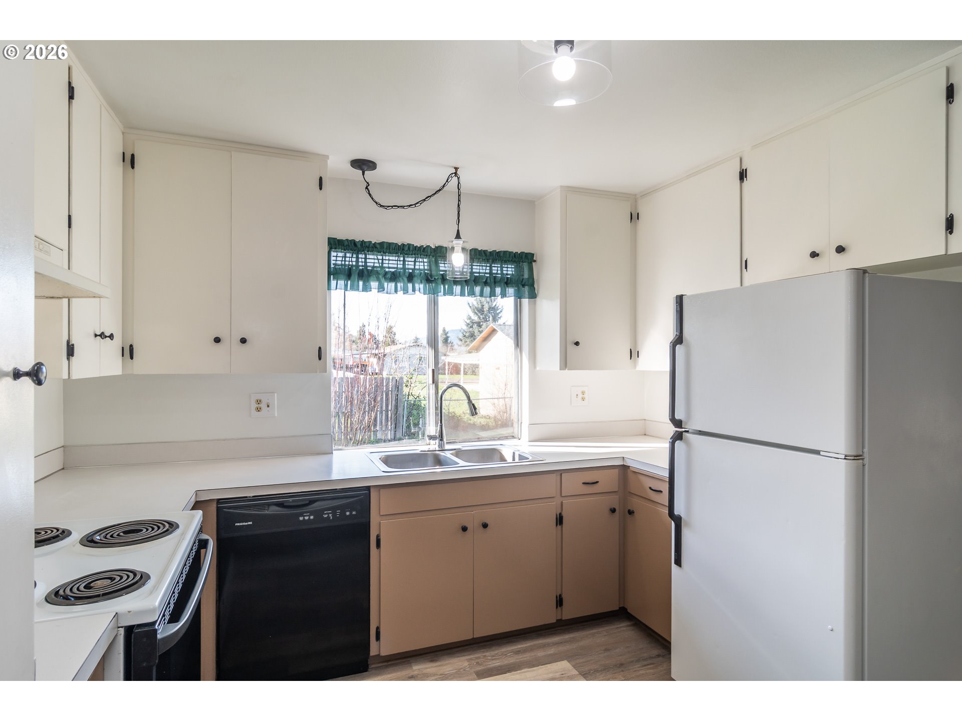 219 Hawthorne Street Sutherlin, OR 97479 - Photo 15 of 45 a kitchen with a refrigerator a sink and cabinets