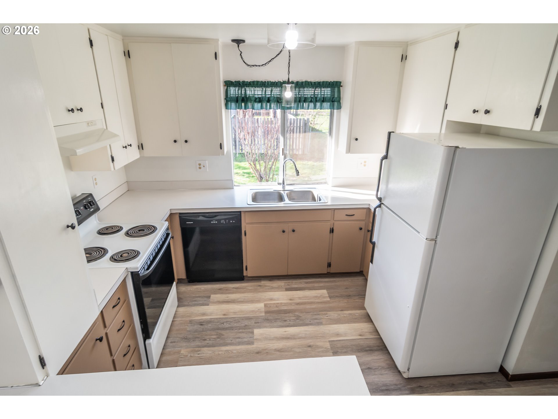 219 Hawthorne Street Sutherlin, OR 97479 - Photo 16 of 45 a kitchen with stainless steel appliances a stove a sink and a refrigerator