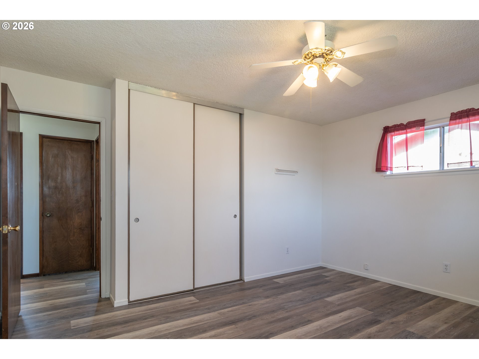 219 Hawthorne Street Sutherlin, OR 97479 - Photo 19 of 45 a view of an empty room with wooden floor