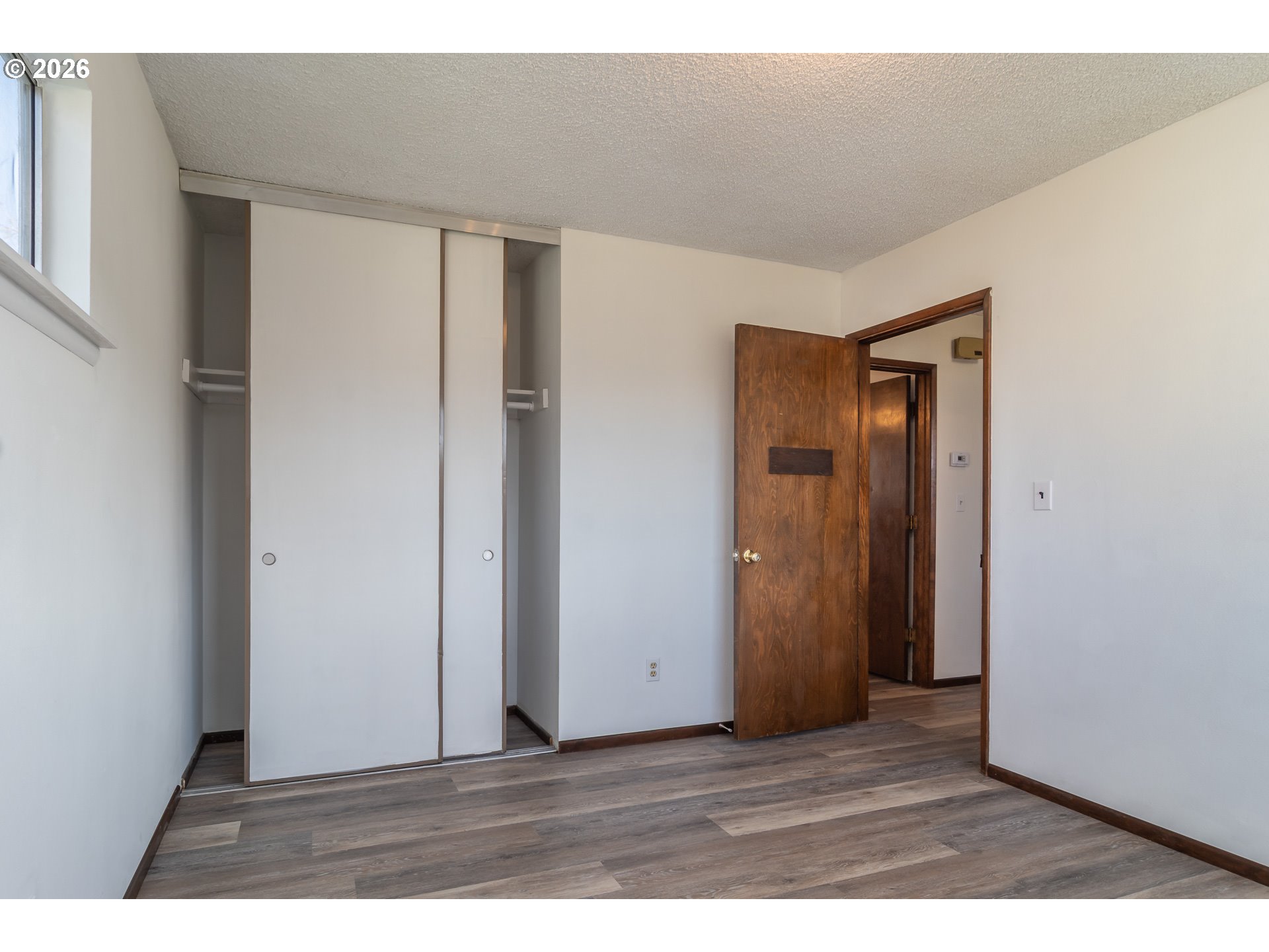 219 Hawthorne Street Sutherlin, OR 97479 - Photo 29 of 45 a view of an empty room with wooden floor