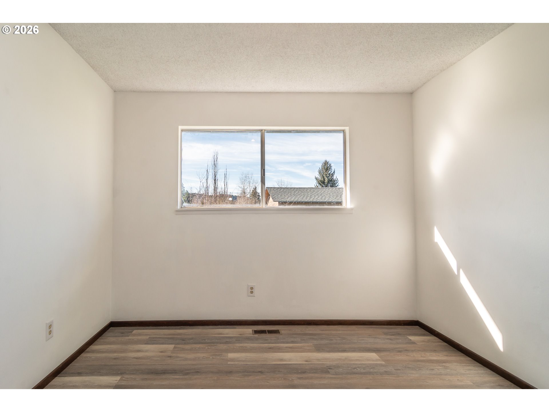 219 Hawthorne Street Sutherlin, OR 97479 - Photo 34 of 45 an empty room with wooden floor and windows