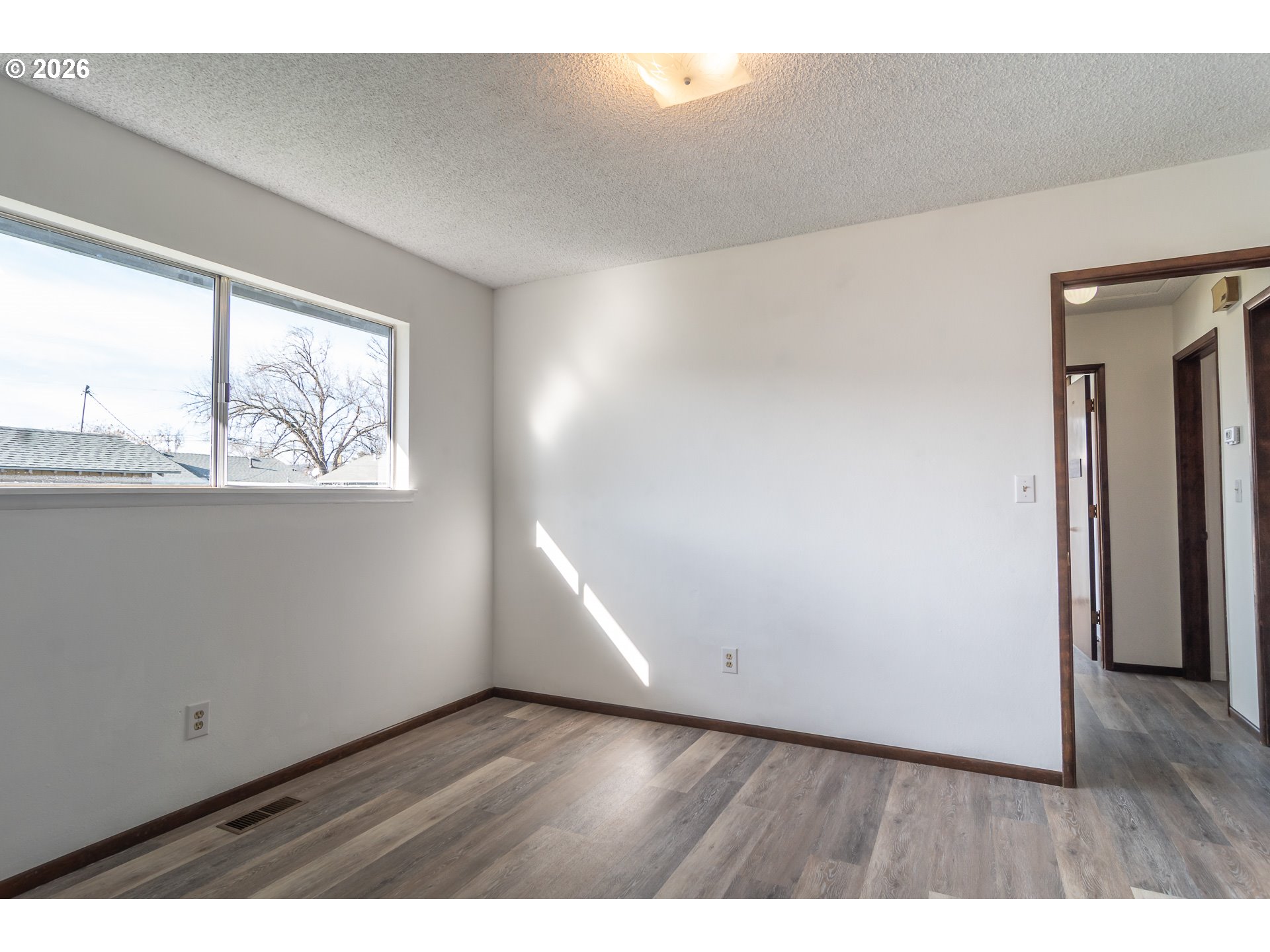 219 Hawthorne Street Sutherlin, OR 97479 - Photo 35 of 45 a view of an empty room with wooden floor and a window