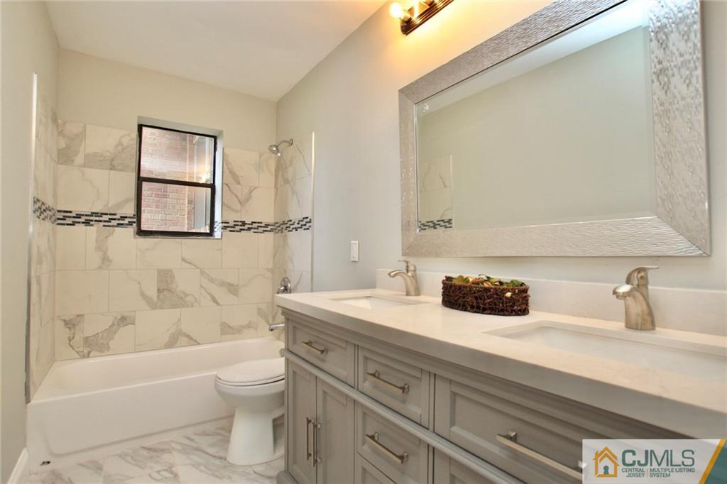 1704 Raspberry Court, Unit 1704 Edison, NJ 08817 - Photo 14 of 23 a bathroom with a sink a toilet and bathtub