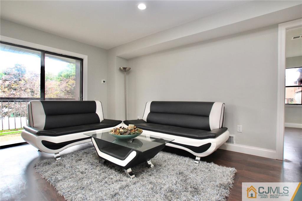 1704 Raspberry Court, Unit 1704 Edison, NJ 08817 - Photo 8 of 23 a living room with furniture a rug and a large window