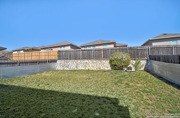 a view of a garden with a house in the background
