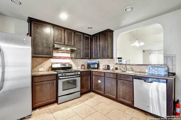 a kitchen with granite countertop stainless steel appliances and sink