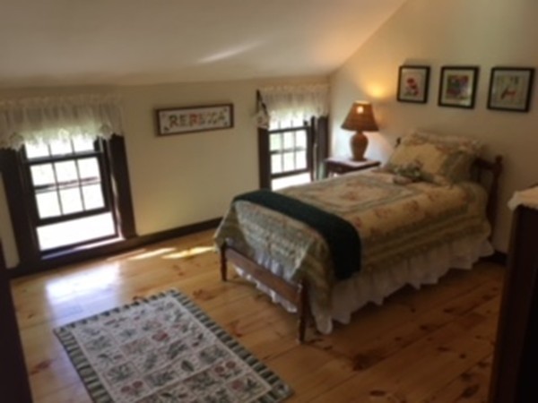 130 Argilla Road Andover, MA 01810 - Photo 12 of 24 a bedroom with a bed next to a window with a flat screen tv