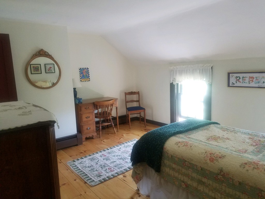 130 Argilla Road Andover, MA 01810 - Photo 13 of 24 a bedroom with a bed a table and chair