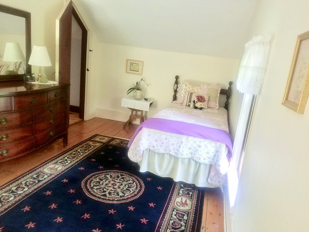 130 Argilla Road Andover, MA 01810 - Photo 15 of 24 a bedroom with a bed and a mirror