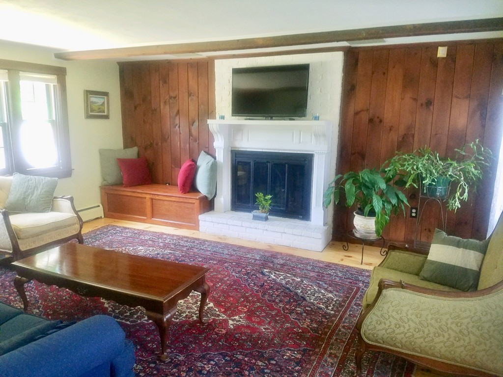 130 Argilla Road Andover, MA 01810 - Photo 4 of 24 a living room with furniture and a fireplace