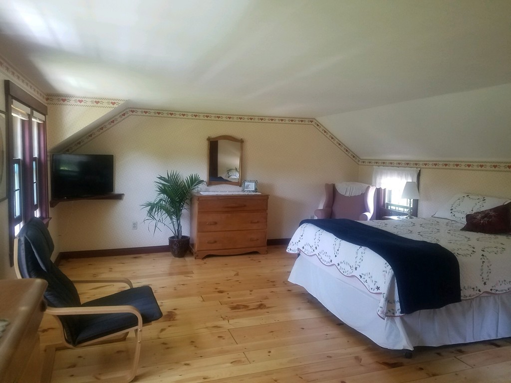 130 Argilla Road Andover, MA 01810 - Photo 10 of 24 a spacious bedroom with a bed and a flat screen television
