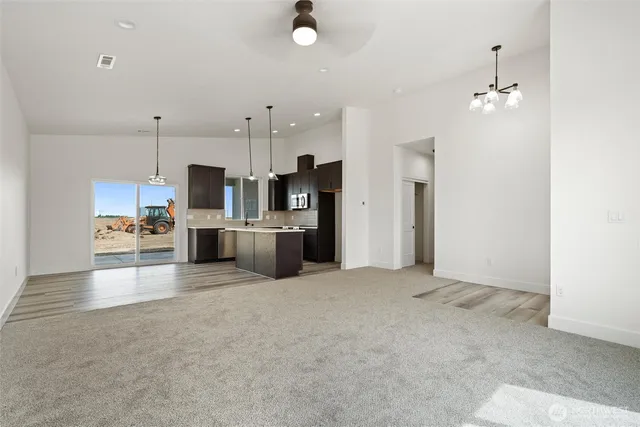 a view of kitchen with stainless steel appliances kitchen island a sink cabinets and wooden floor