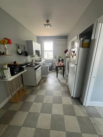 a kitchen with a sink a stove and cabinets