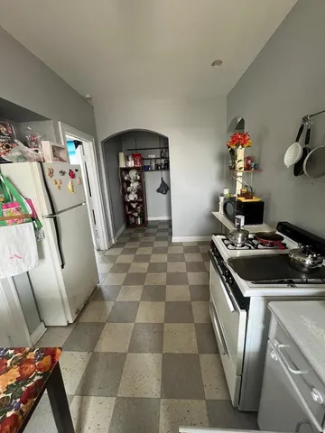 a kitchen with stainless steel appliances granite countertop a stove a refrigerator and a sink