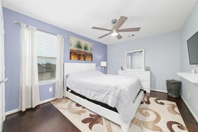 a spacious bedroom with a bed and a window