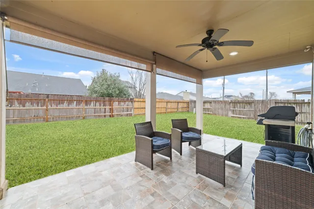 a view of a porch with furniture and garden