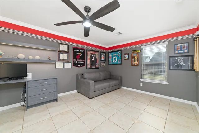 a living room with furniture and a ceiling fan