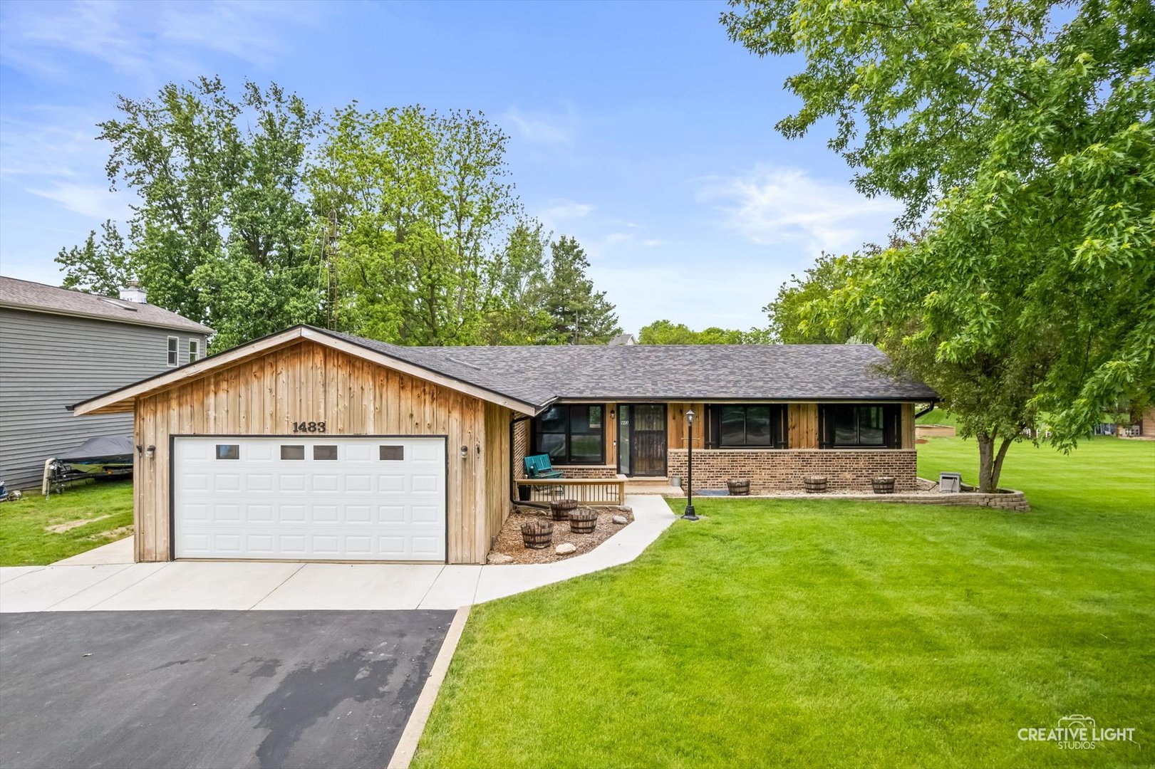 1483 Nova Road Sandwich, IL 60548 - Photo 2 of 29 a front view of a house with a garden and trees