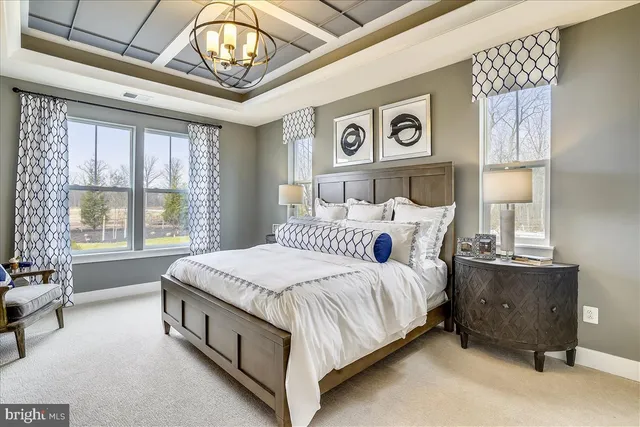 a spacious bedroom with a bed and a table in it