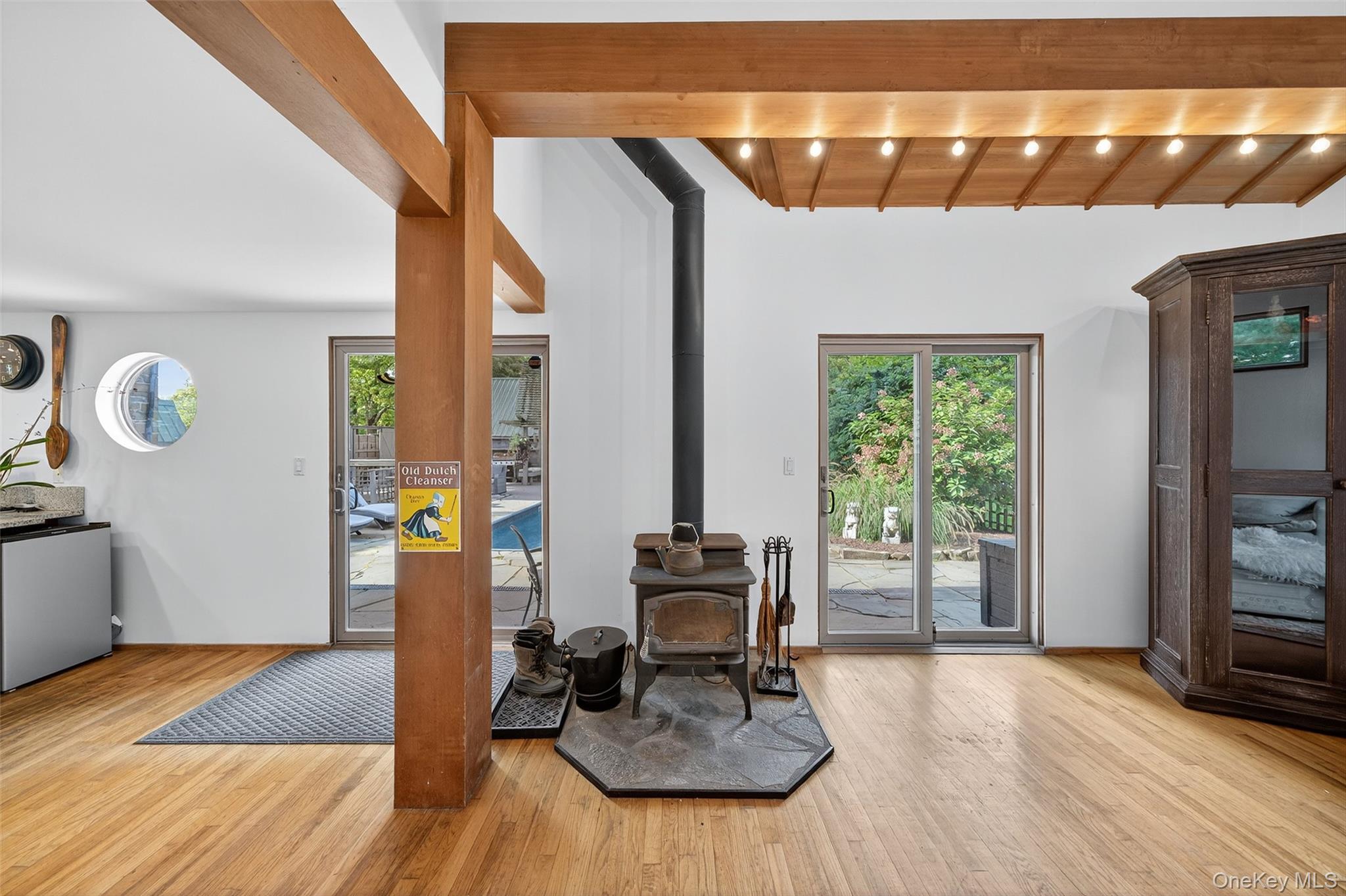 441 Scotchtown Collabar Road Middletown, NY 10941 - Photo 21 of 48 Living room with a wood stove, wood finished floors, plenty of natural light, and a wooden ceiling with exposed beams