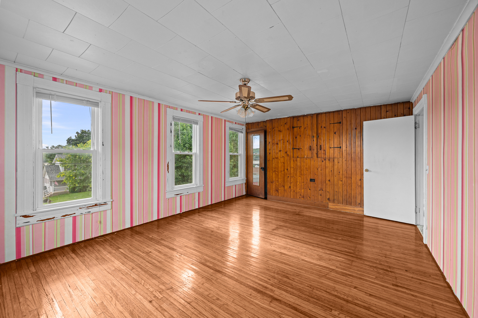 802 North High Street Port Byron, IL 61275 - Photo 37 of 43 a view of an empty room with wooden floor and a window