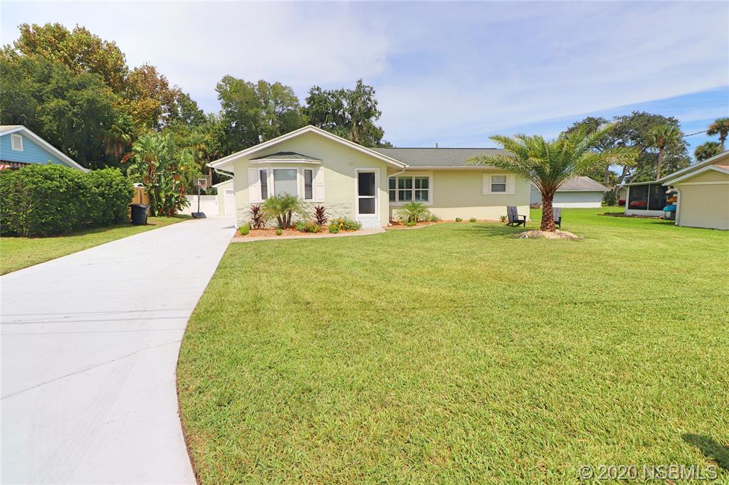 129 Rhode Island Street Edgewater, FL 32132 - Photo 1 of 49 a front view of a house with garden