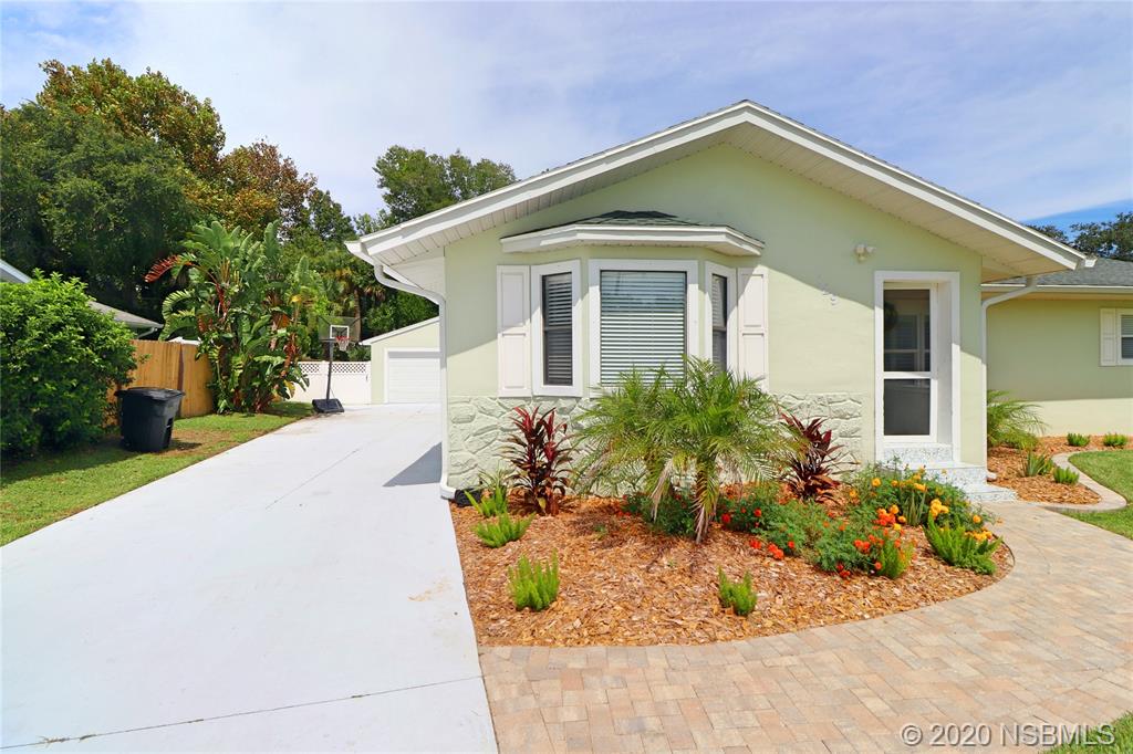 129 Rhode Island Street Edgewater, FL 32132 - Photo 2 of 49 a front view of a house with a yard