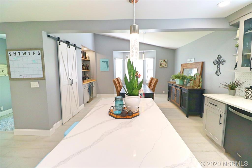 129 Rhode Island Street Edgewater, FL 32132 - Photo 15 of 49 a view of a kitchen with kitchen island a counter top space and stainless steel appliances