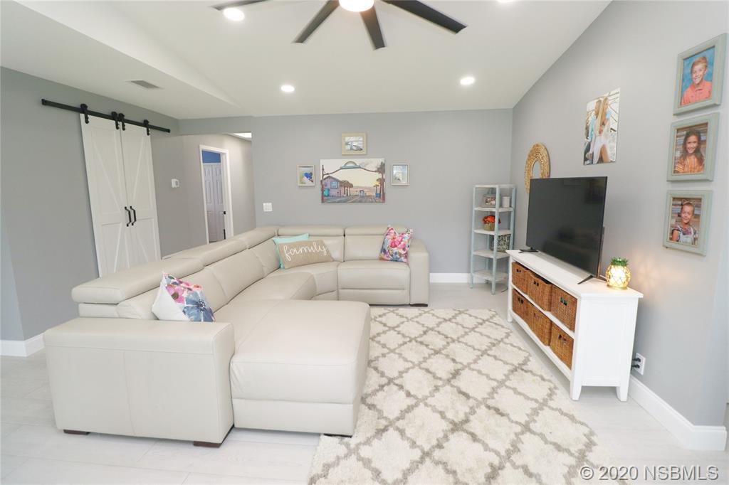129 Rhode Island Street Edgewater, FL 32132 - Photo 18 of 49 a living room with furniture and a flat screen tv