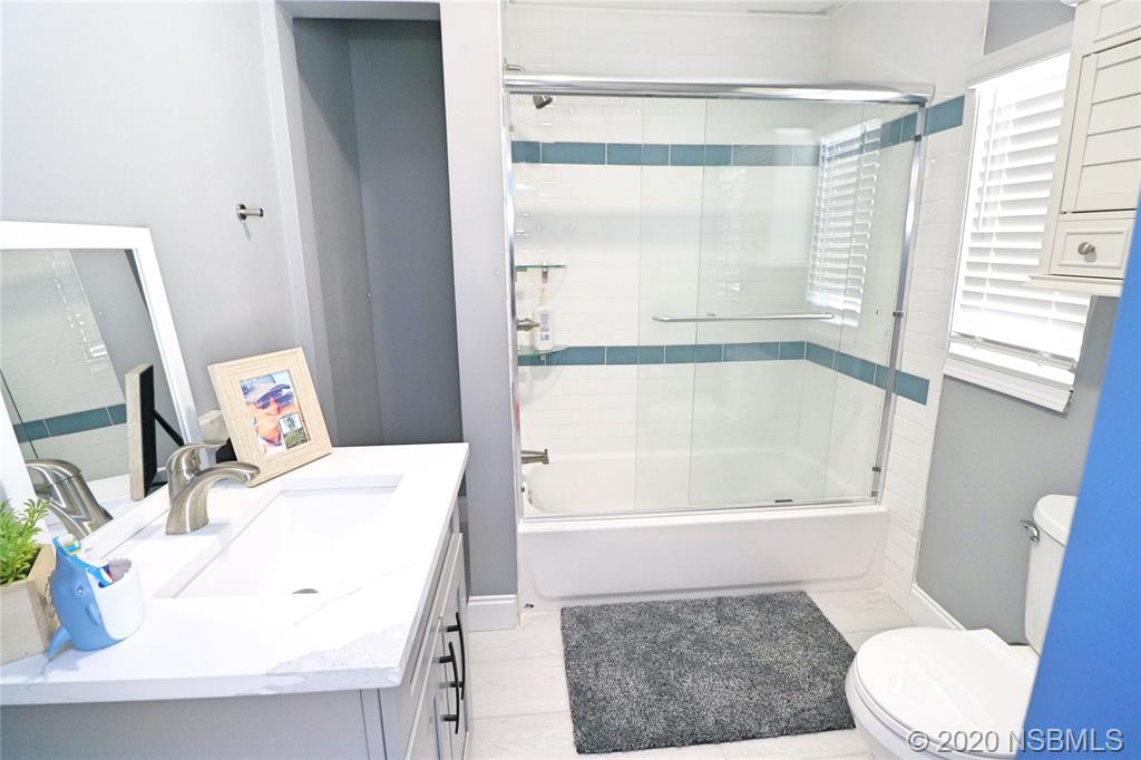 129 Rhode Island Street Edgewater, FL 32132 - Photo 20 of 49 a bathroom with a sink a toilet and shower