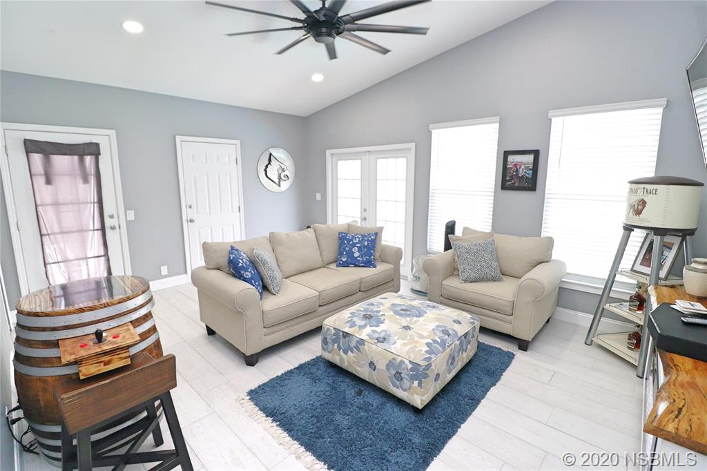 129 Rhode Island Street Edgewater, FL 32132 - Photo 22 of 49 a living room with furniture a ceiling fan a rug and a window