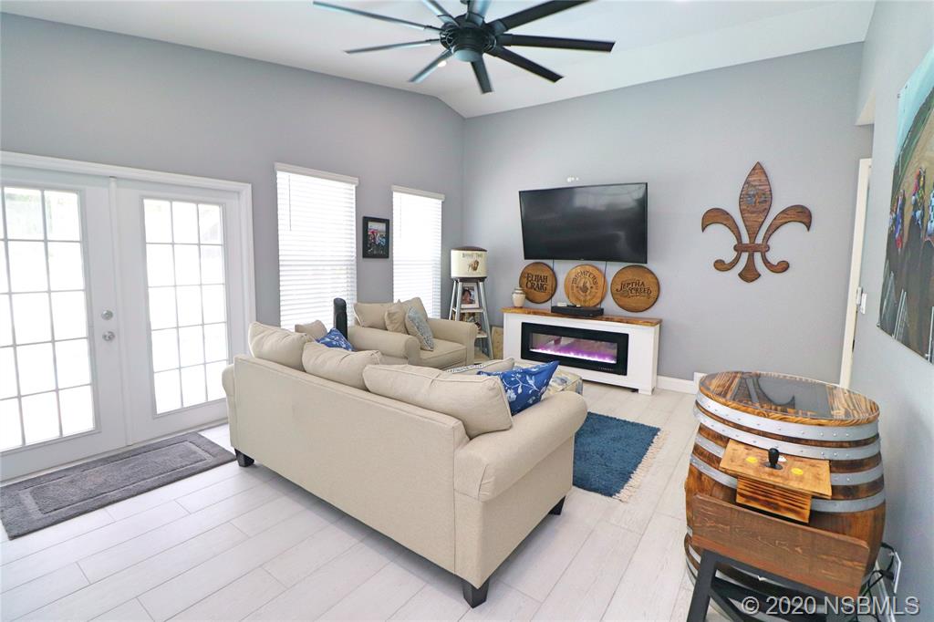 129 Rhode Island Street Edgewater, FL 32132 - Photo 23 of 49 a living room with furniture and a flat screen tv