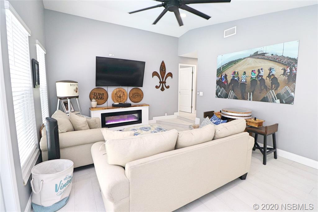 129 Rhode Island Street Edgewater, FL 32132 - Photo 24 of 49 a living room with furniture and a flat screen tv
