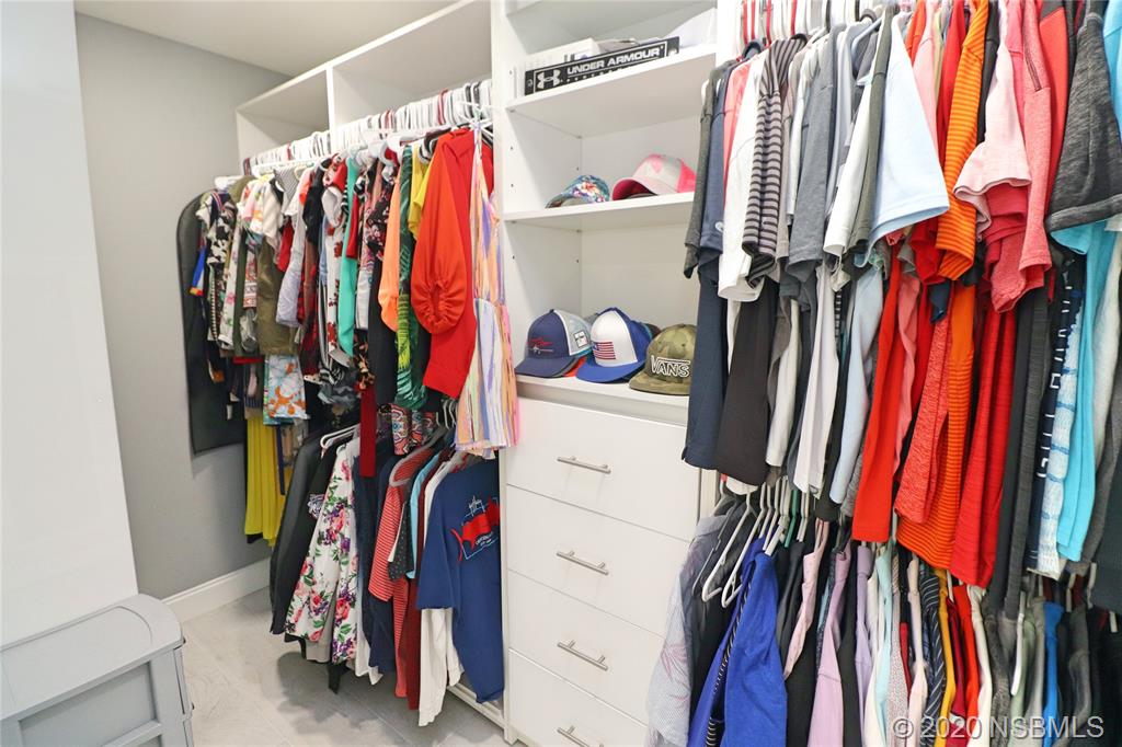 129 Rhode Island Street Edgewater, FL 32132 - Photo 29 of 49 a view of walk in closet with clothes