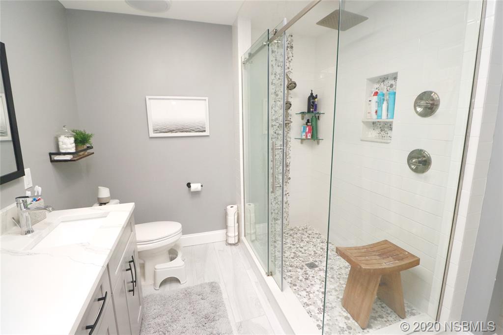 129 Rhode Island Street Edgewater, FL 32132 - Photo 30 of 49 a bathroom with a sink a toilet and shower
