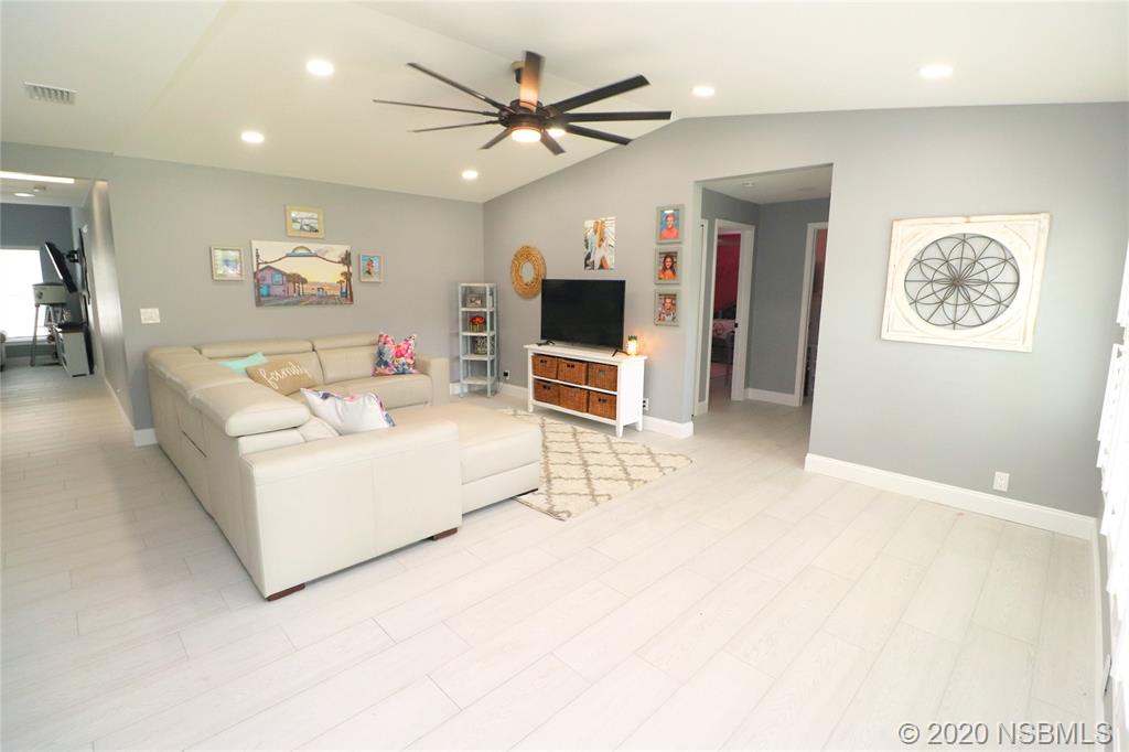 129 Rhode Island Street Edgewater, FL 32132 - Photo 4 of 49 a living room with furniture and a flat screen tv