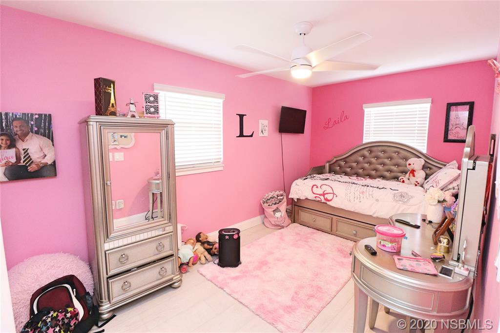129 Rhode Island Street Edgewater, FL 32132 - Photo 33 of 49 a bedroom with a bed and a dresser