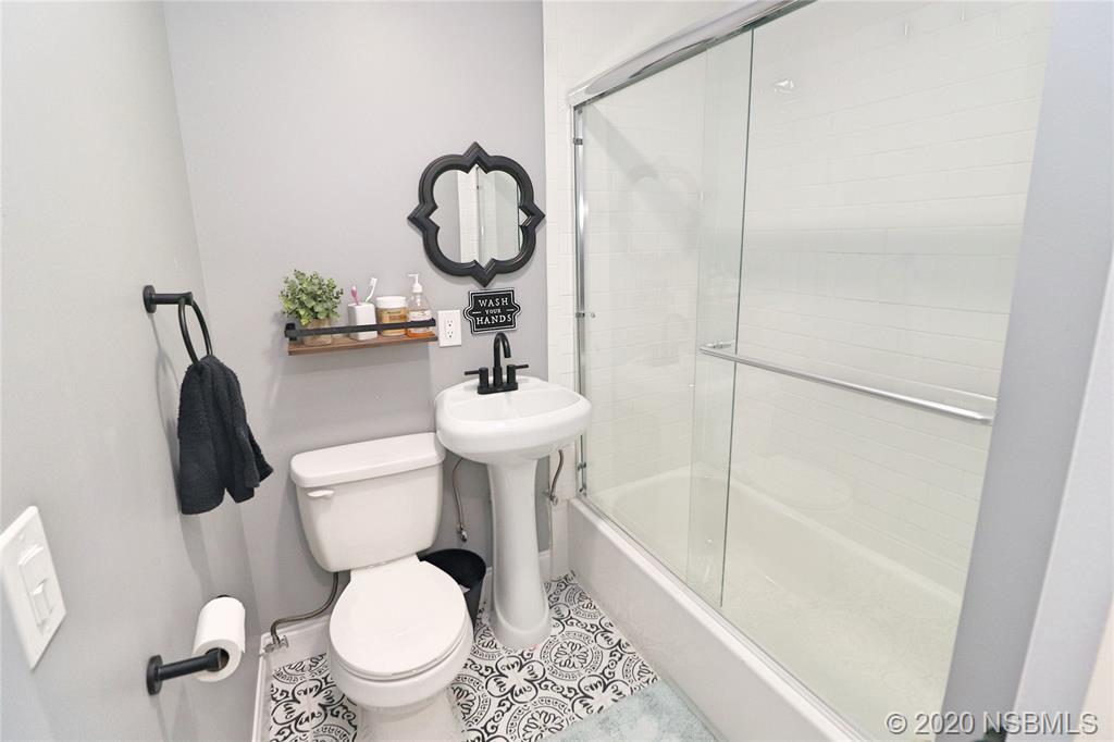 129 Rhode Island Street Edgewater, FL 32132 - Photo 35 of 49 a white toilet sitting next to a bathroom sink and tub