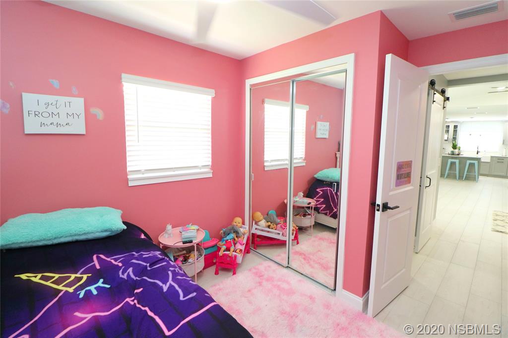 129 Rhode Island Street Edgewater, FL 32132 - Photo 37 of 49 a bedroom with a bed and a window