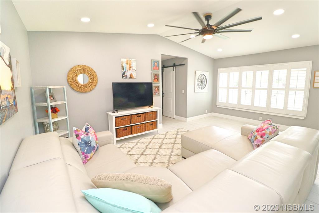 129 Rhode Island Street Edgewater, FL 32132 - Photo 5 of 49 a living room with furniture and a flat screen tv
