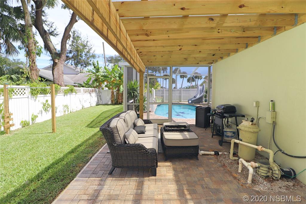 129 Rhode Island Street Edgewater, FL 32132 - Photo 42 of 49 a living room with patio furniture and garden