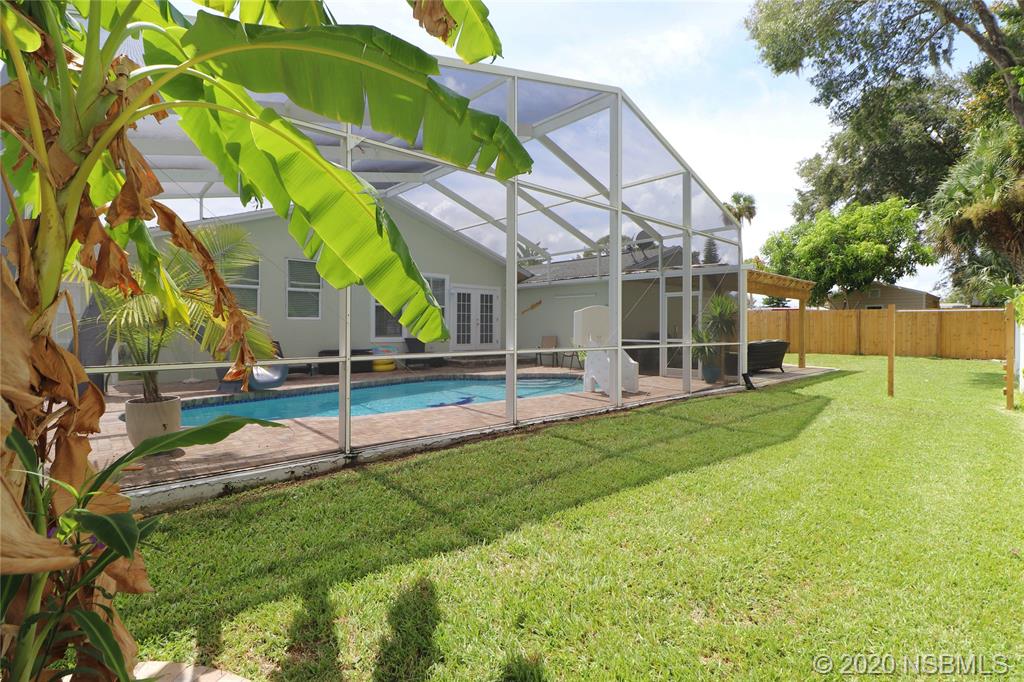 129 Rhode Island Street Edgewater, FL 32132 - Photo 43 of 49 a view of a house with backyard and a tree