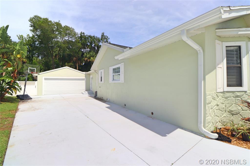 129 Rhode Island Street Edgewater, FL 32132 - Photo 44 of 49 a white house with tree in front of it