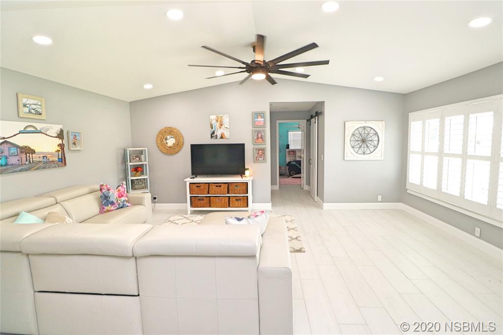 129 Rhode Island Street Edgewater, FL 32132 - Photo 6 of 49 a living room with furniture and a flat screen tv