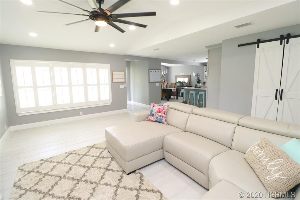 129 Rhode Island Street Edgewater, FL 32132 - Photo 7 of 49 a living room with furniture and a large window